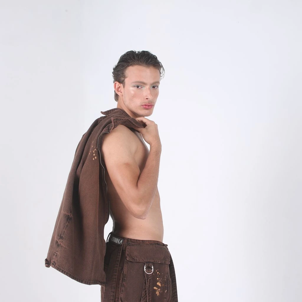 Runway model styled in an editorial charcoal overcoat for a prêt-à-porter show.